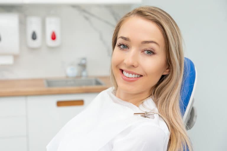 Young,Smiling,Woman,Sitting,On,Chair,At,Dentist,Office.,Dental