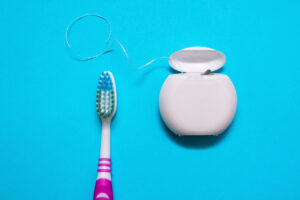 Picture of a toothbrush and dental floss.