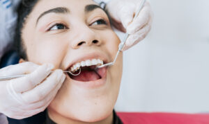 Picture of a woman receiving a root canal at the dentist.